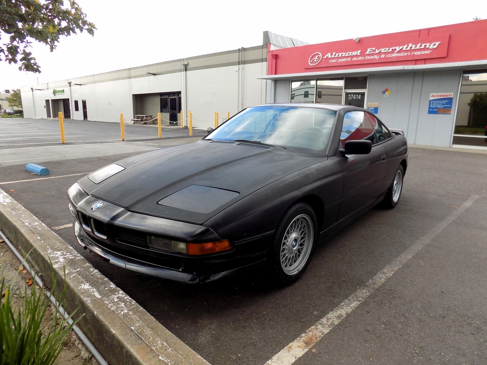 1992 BMW 850i before its complete paint job, outside the Almost Everything storefront